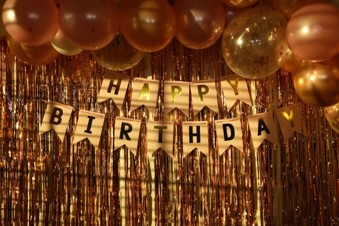 a happy birthday banner with balloons and streamers